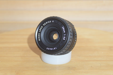 Vintage Nikon E Series 28mm f2.8 lens. This is a fantastic wide angle lens in great condition.