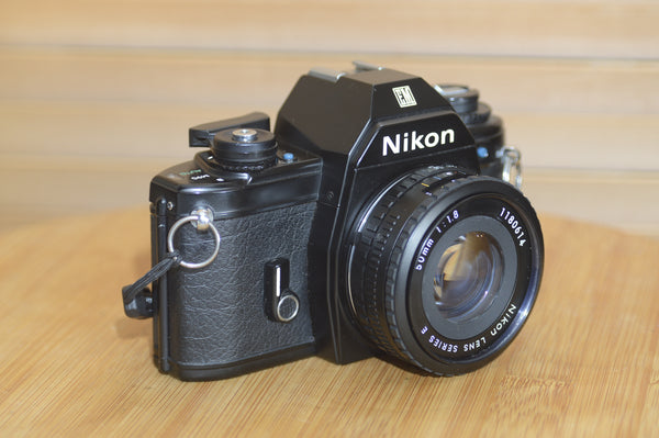 Beautiful Nikon EM 35mm Camera and 50mm f1.8 lens. Very stylish little vintage SLR.