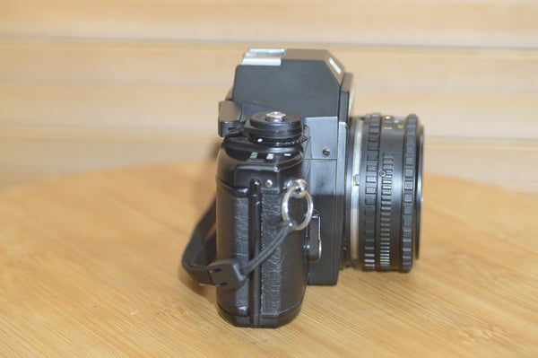 Beautiful Nikon EM 35mm Camera and 50mm f1.8 lens. Very stylish little vintage SLR.