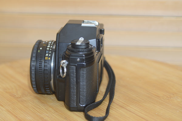 Beautiful Nikon EM 35mm Camera and 50mm f1.8 lens. Very stylish little vintage SLR.