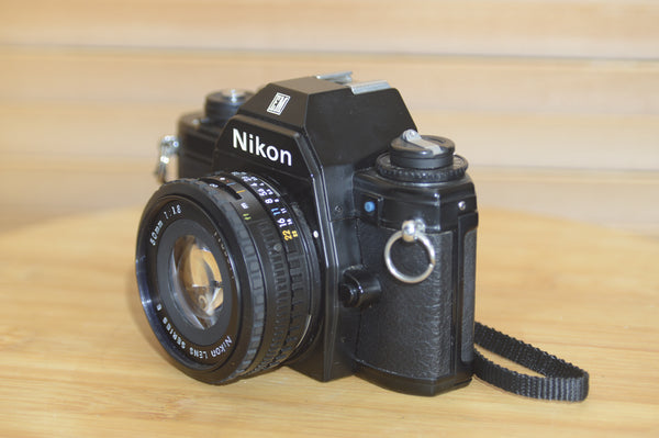 Beautiful Nikon EM 35mm Camera and 50mm f1.8 lens. Very stylish little vintage SLR.