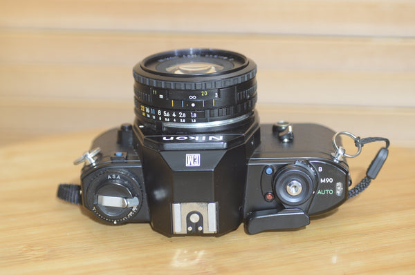 Beautiful Nikon EM 35mm Camera and 50mm f1.8 lens. Very stylish little vintage SLR.