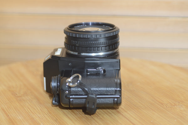 Beautiful Nikon EM 35mm Camera and 50mm f1.8 lens. Very stylish little vintage SLR.